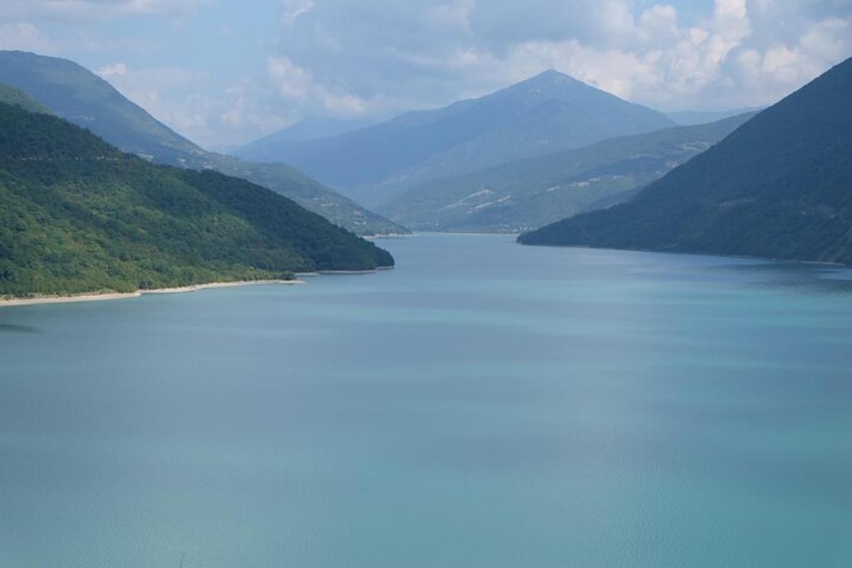 a large body of water with mountains in the background