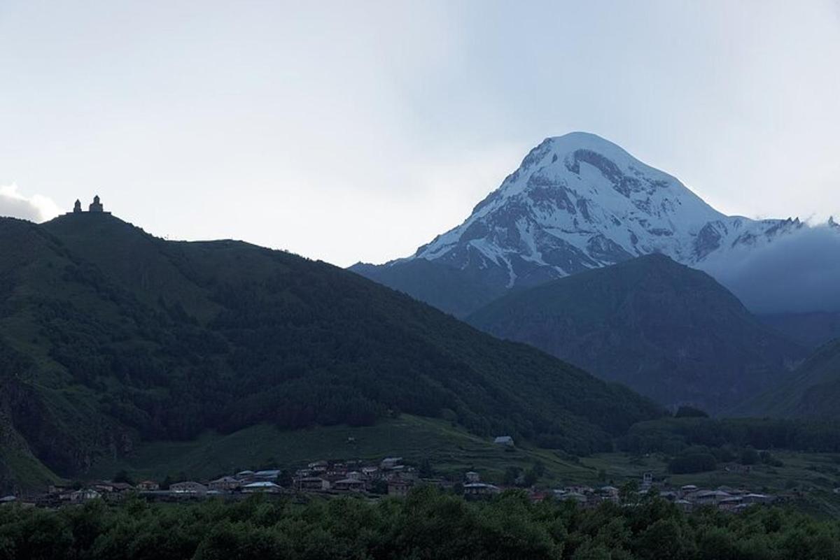 a mountain in the distance with a town in the foreground