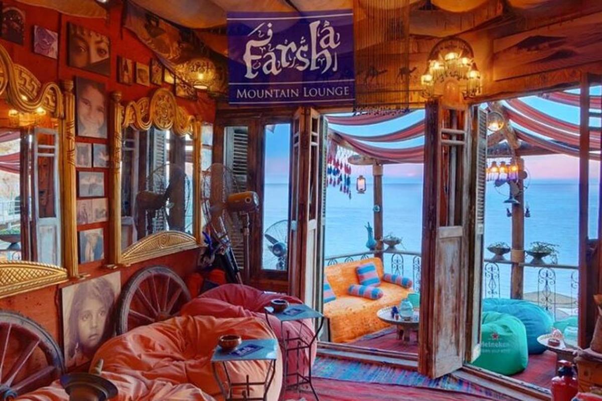 a room with a bed and a view of the ocean