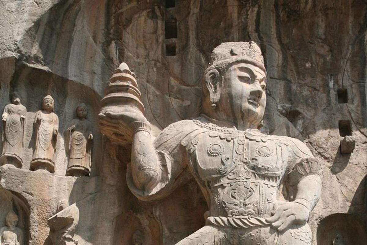 a statue of a man holding a bowl