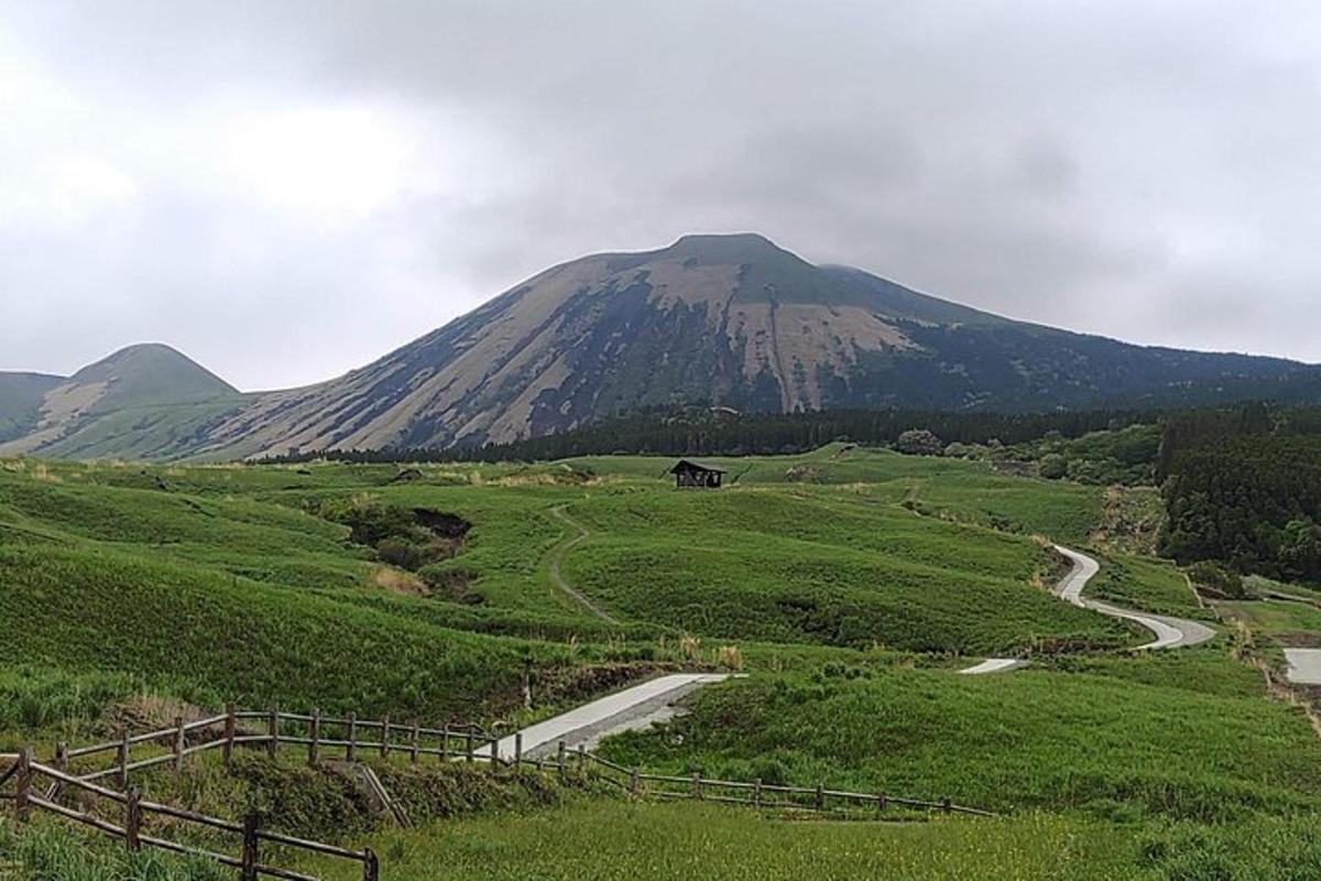 a mountain in the middle of a field with a road