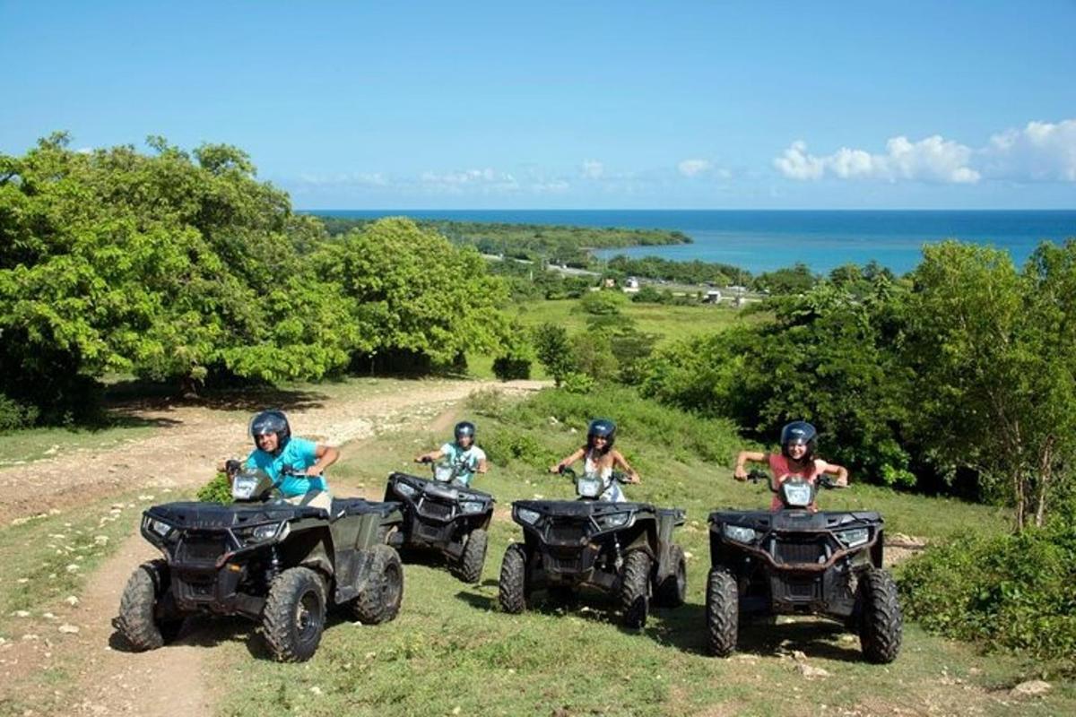 a group of people riding atvs on a dirt road