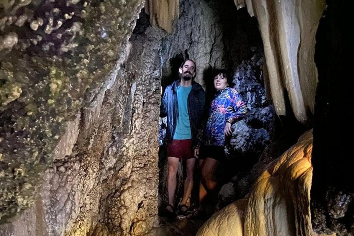 a man and a woman standing in a cave