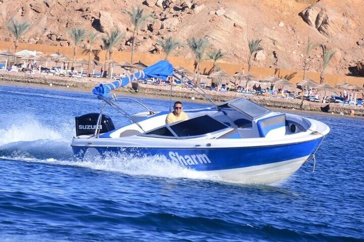 a man in a blue and white boat on the water