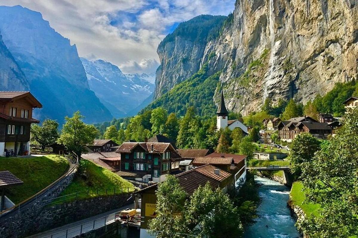 a village in the mountains with a river and a church