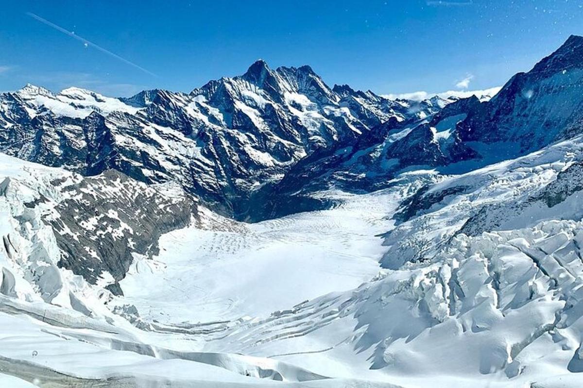 a snowy mountain range with snow covered mountains