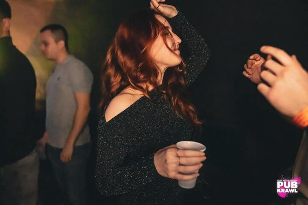 a woman is holding a cup in a party