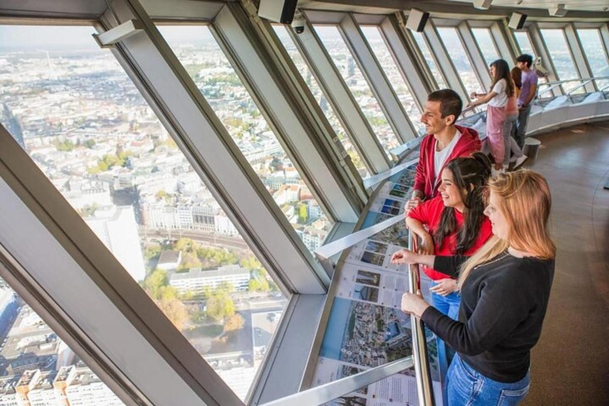 a group of people standing in the observation deck of a building