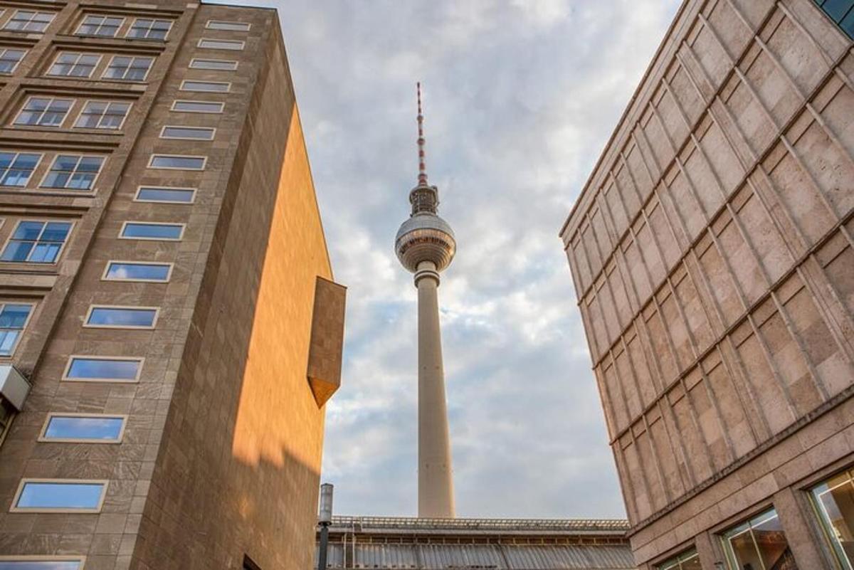a view of the berlin tv tower between two buildings