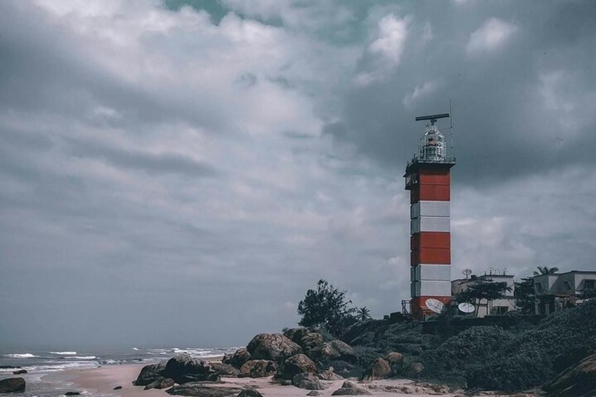 a red and white lighthouse on top of a beach