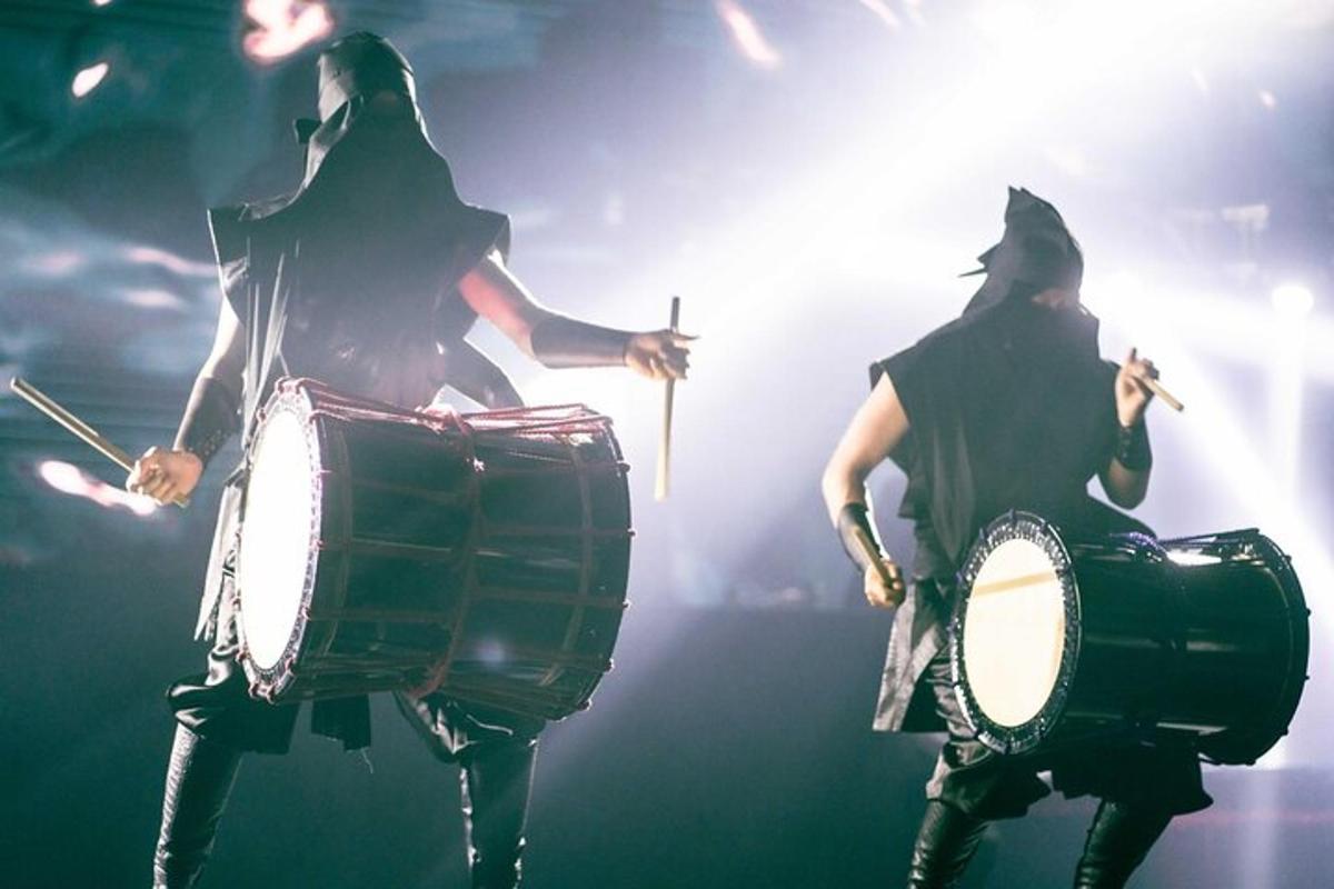 a couple of people dressed in costumes playing drums