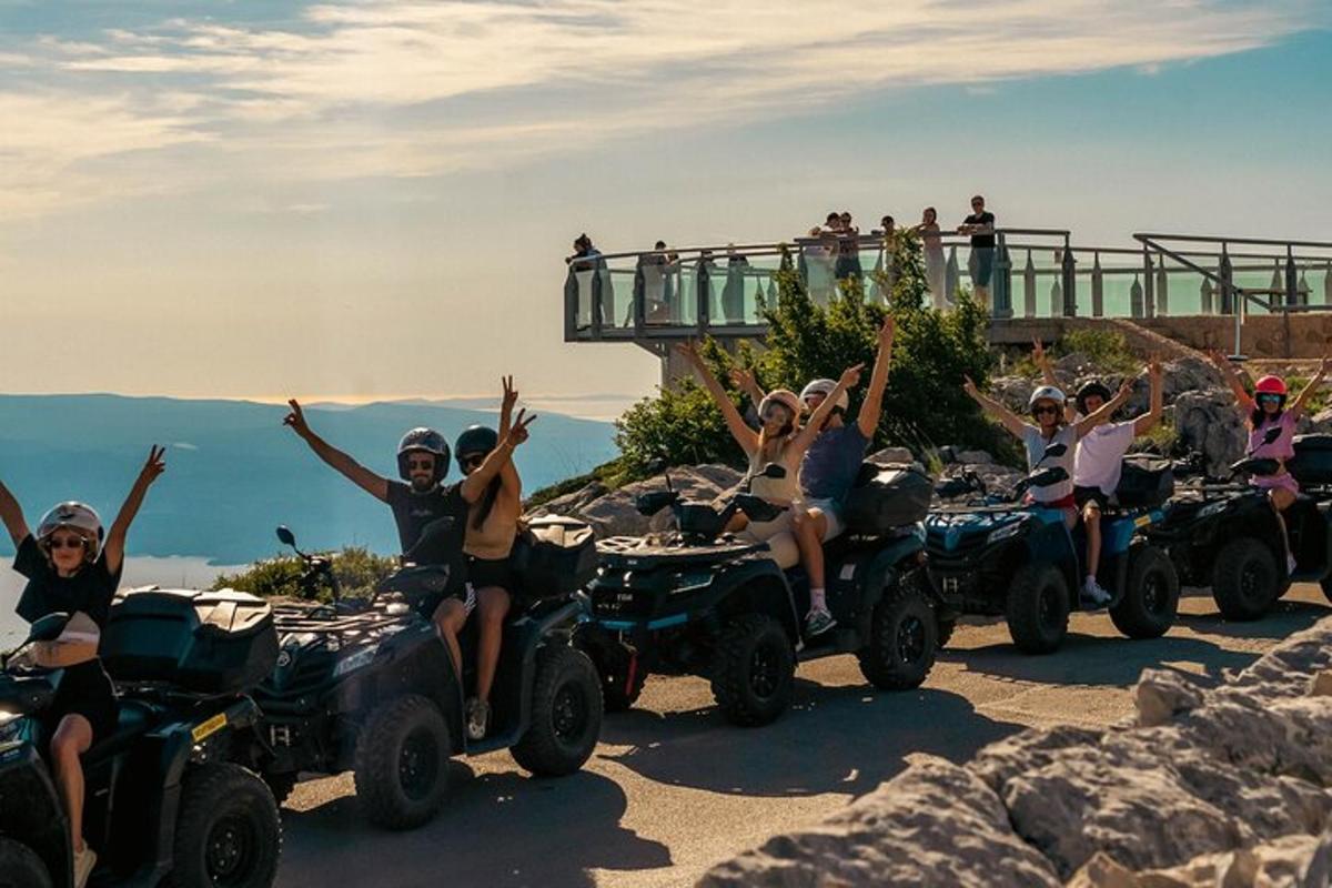 a group of people riding atvs down a mountain