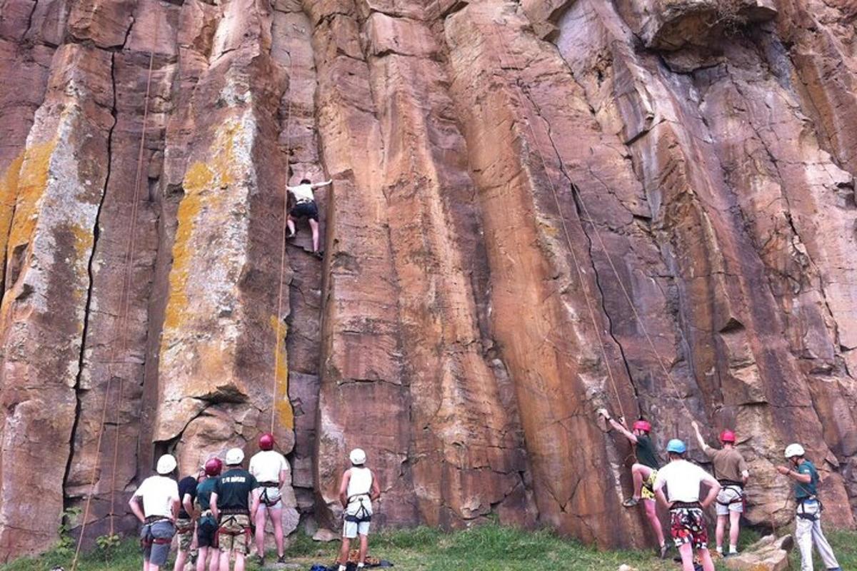 a group of people on bikes climbing a rock wall