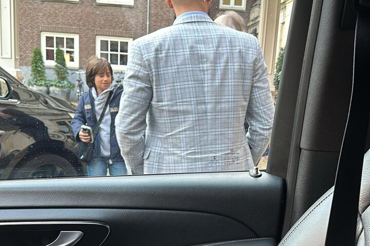 a man and a little girl walking into a car