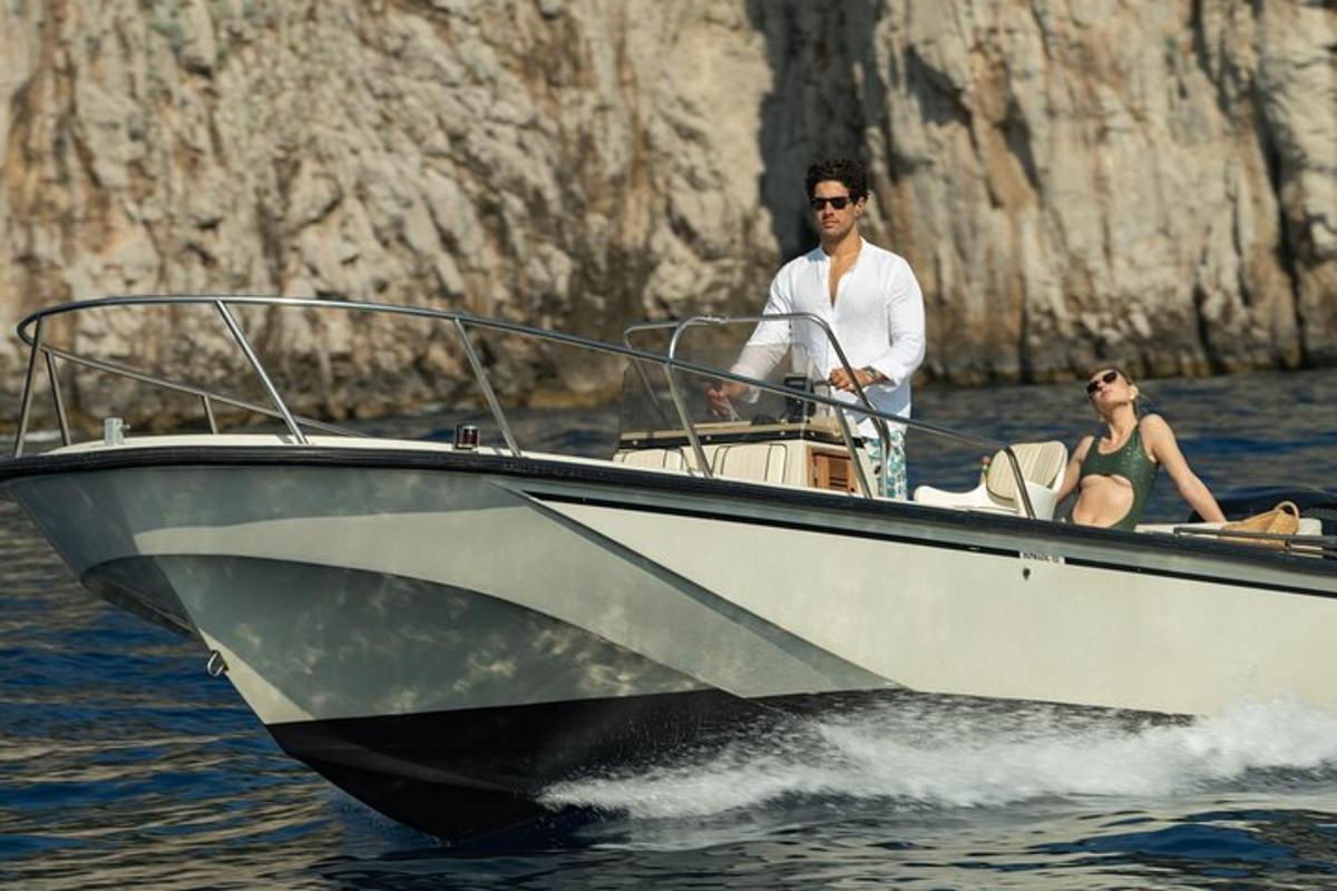 a man and woman on a boat in the water
