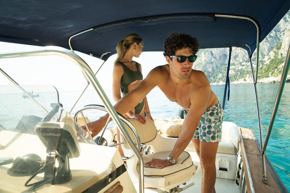 a man and woman on a boat in the water