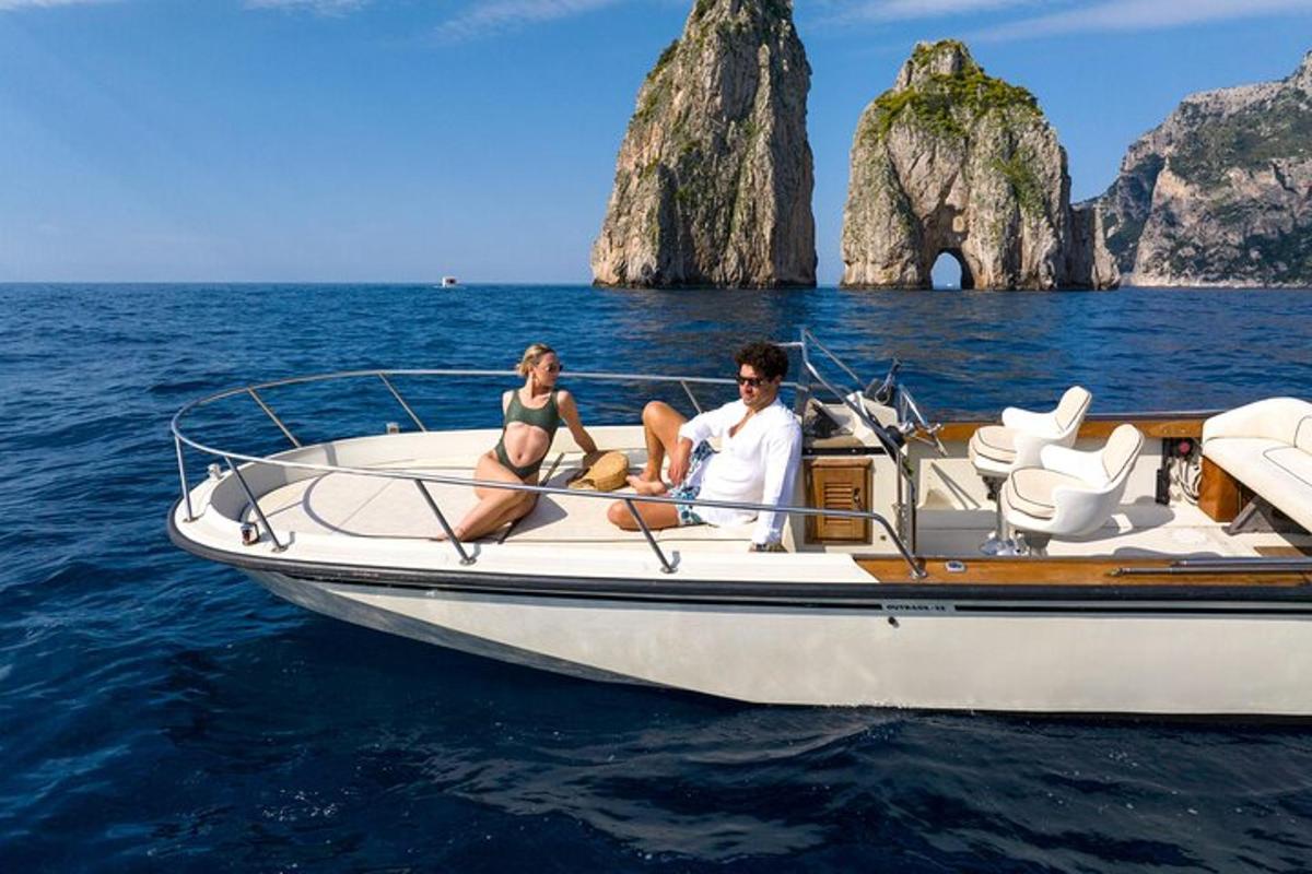 a man and a woman sitting on a boat in the water