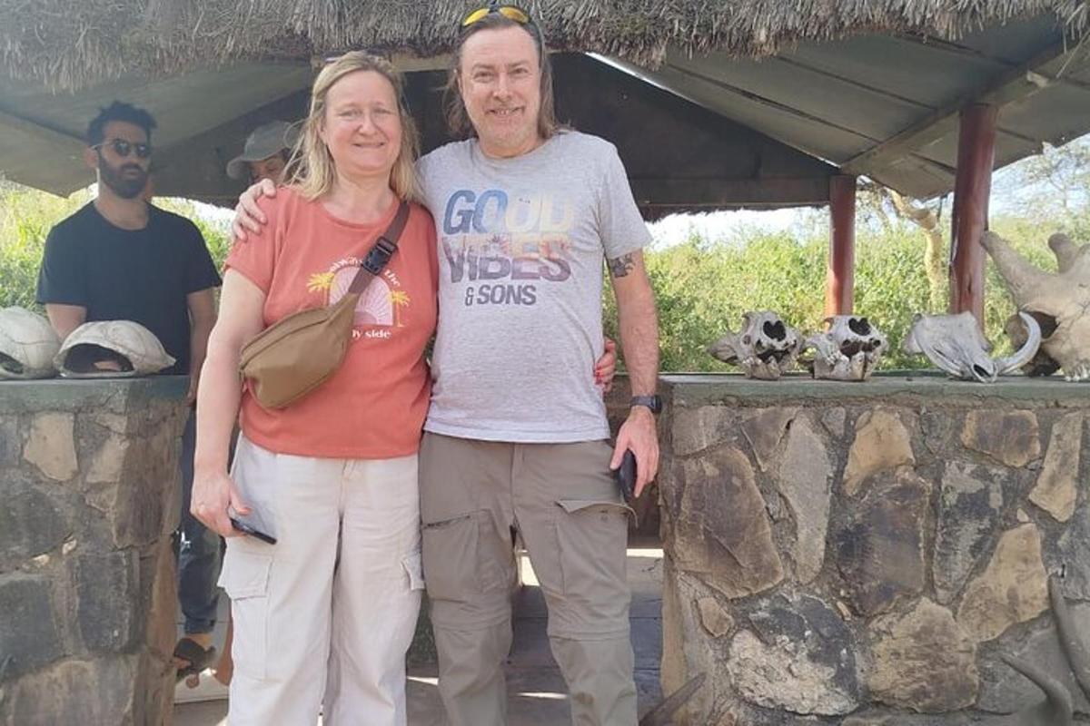 ein Mann und eine Frau stehen neben einer Steinmauer