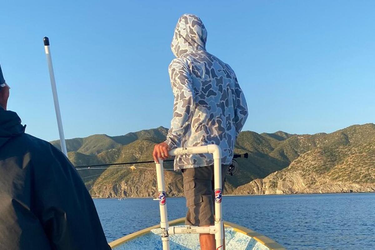 a man sitting on a chair on a boat in the water