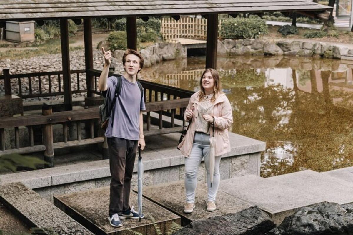 a man and a woman standing on a bridge