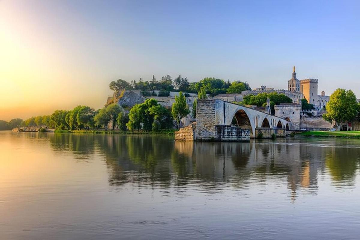 a bridge over a river with a city in the background