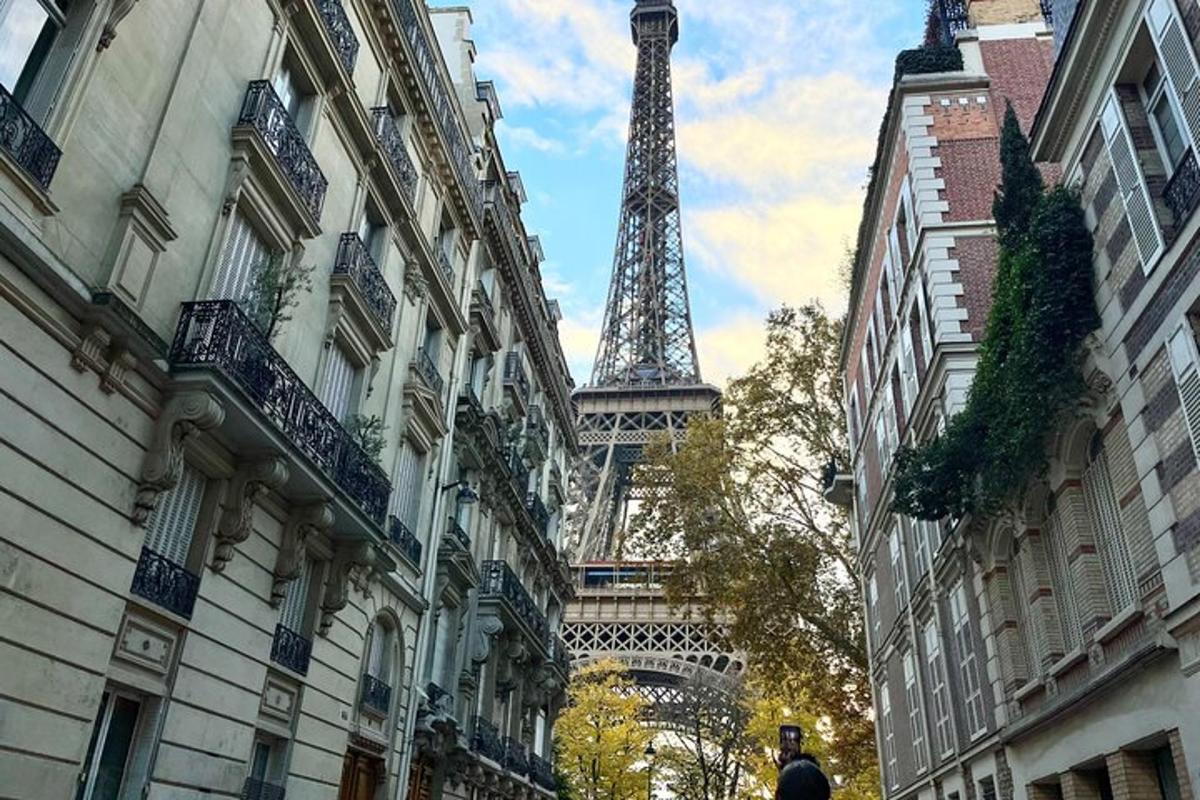 a view of the eiffel tower from between buildings