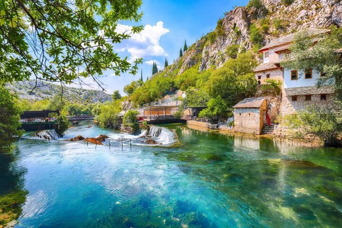 a river with blue water and buildings and a mountain