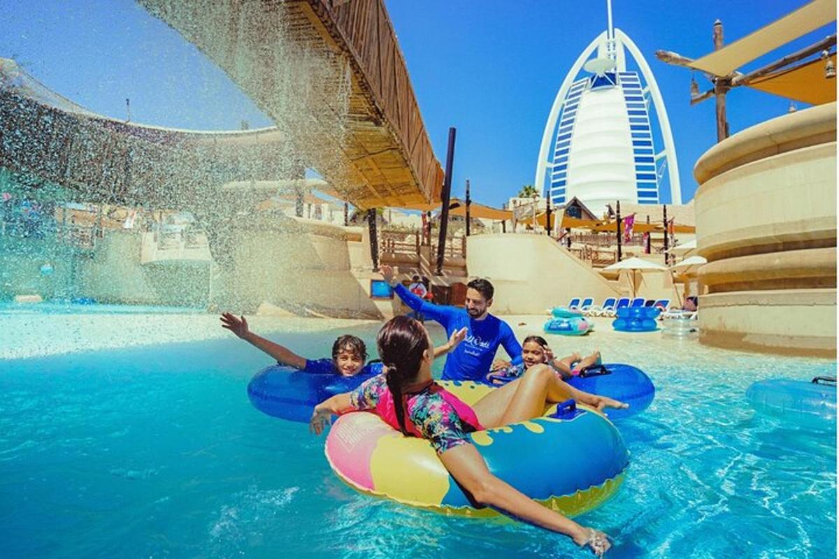 a group of people riding on tubes in the water at a water park