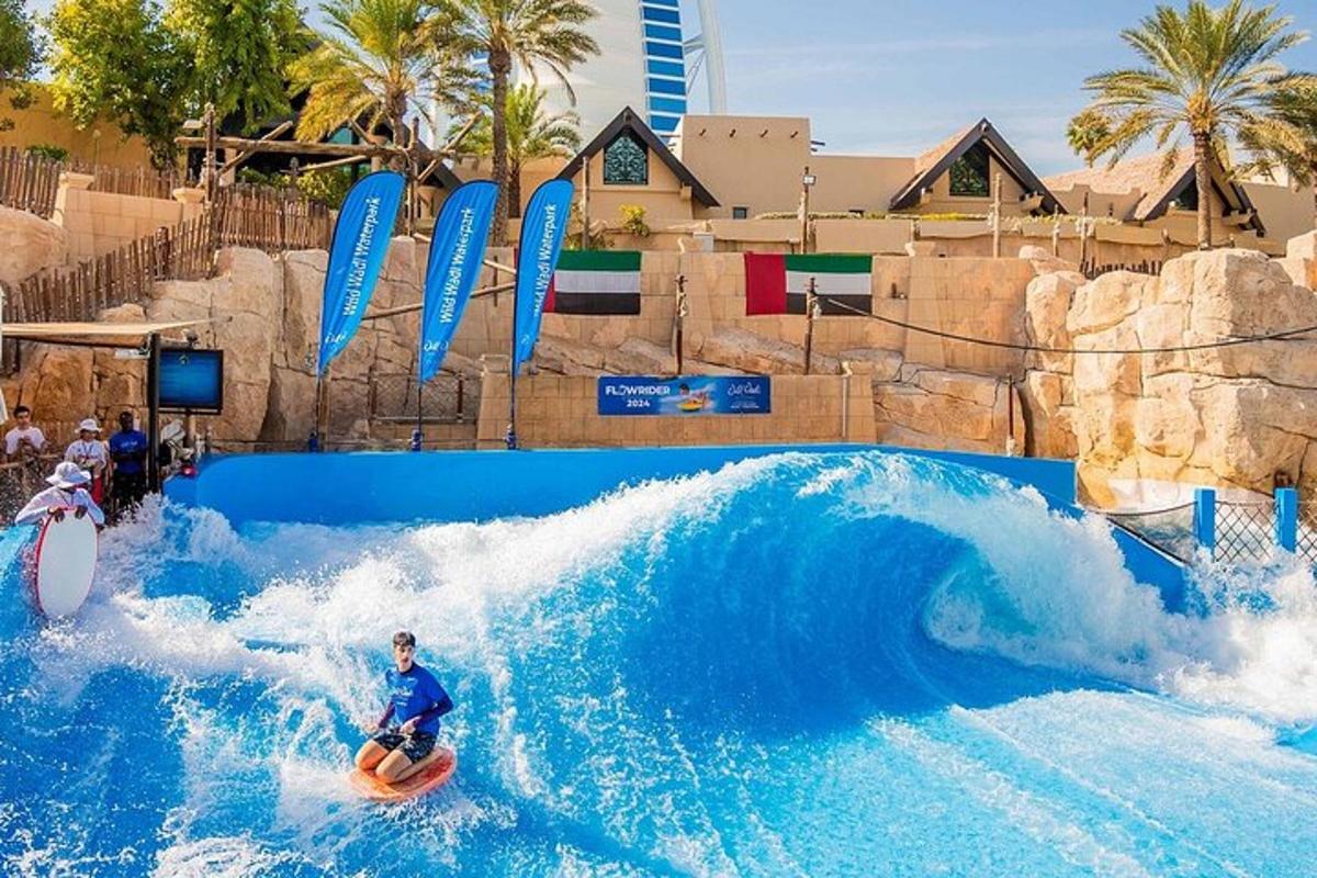 a man riding a wave on a surfboard in a water park