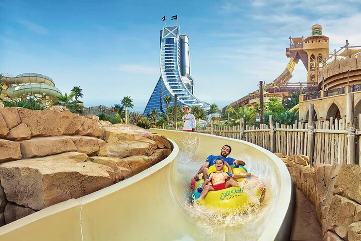a group of people riding a water slide at a theme park