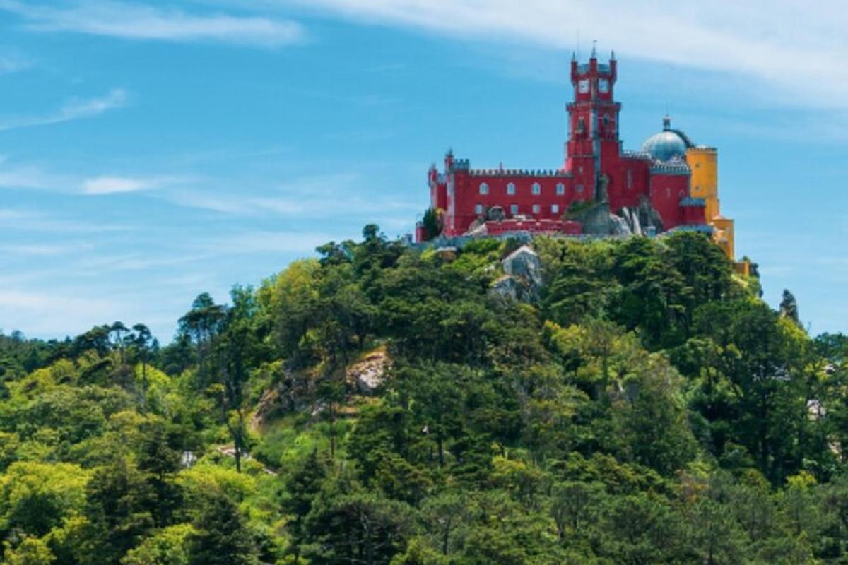a castle on top of a hill with trees