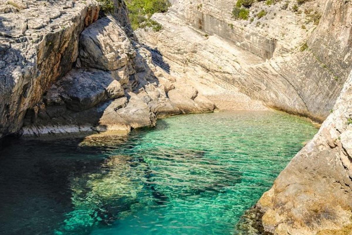 a pool of blue water in a rocky canyon