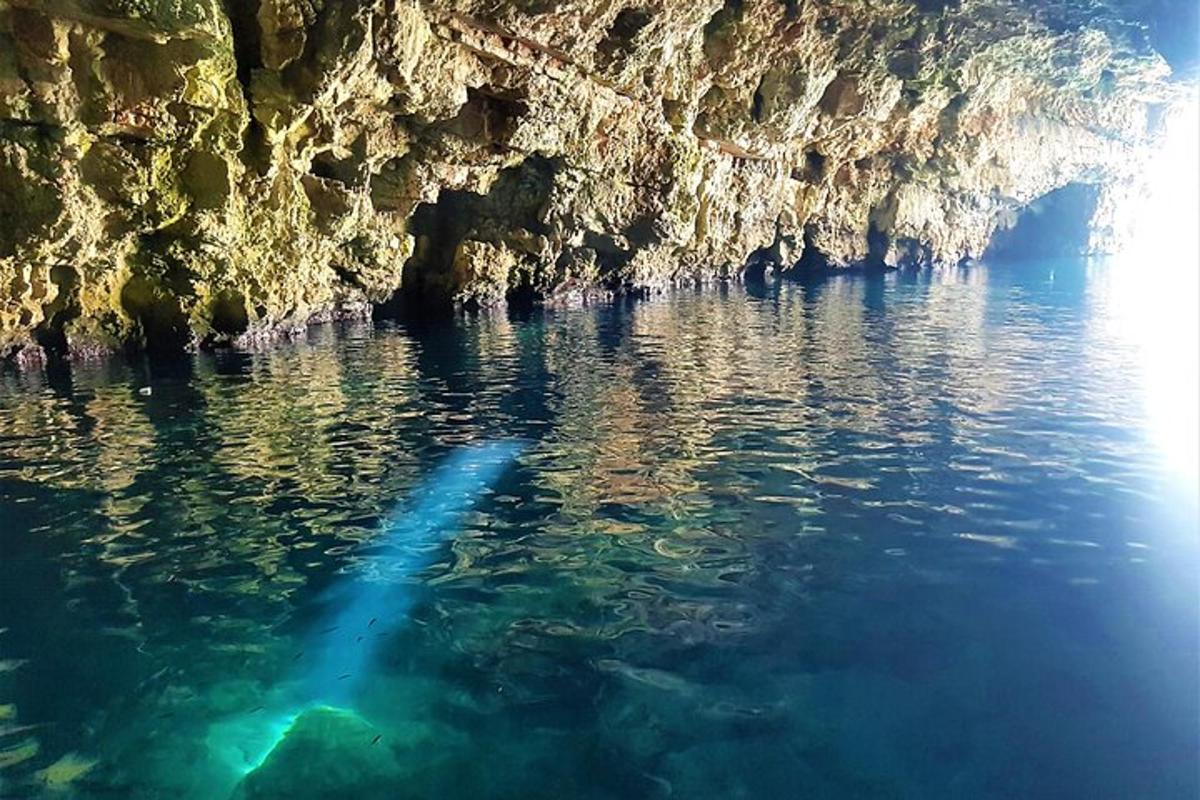 a boat in the water near a cave
