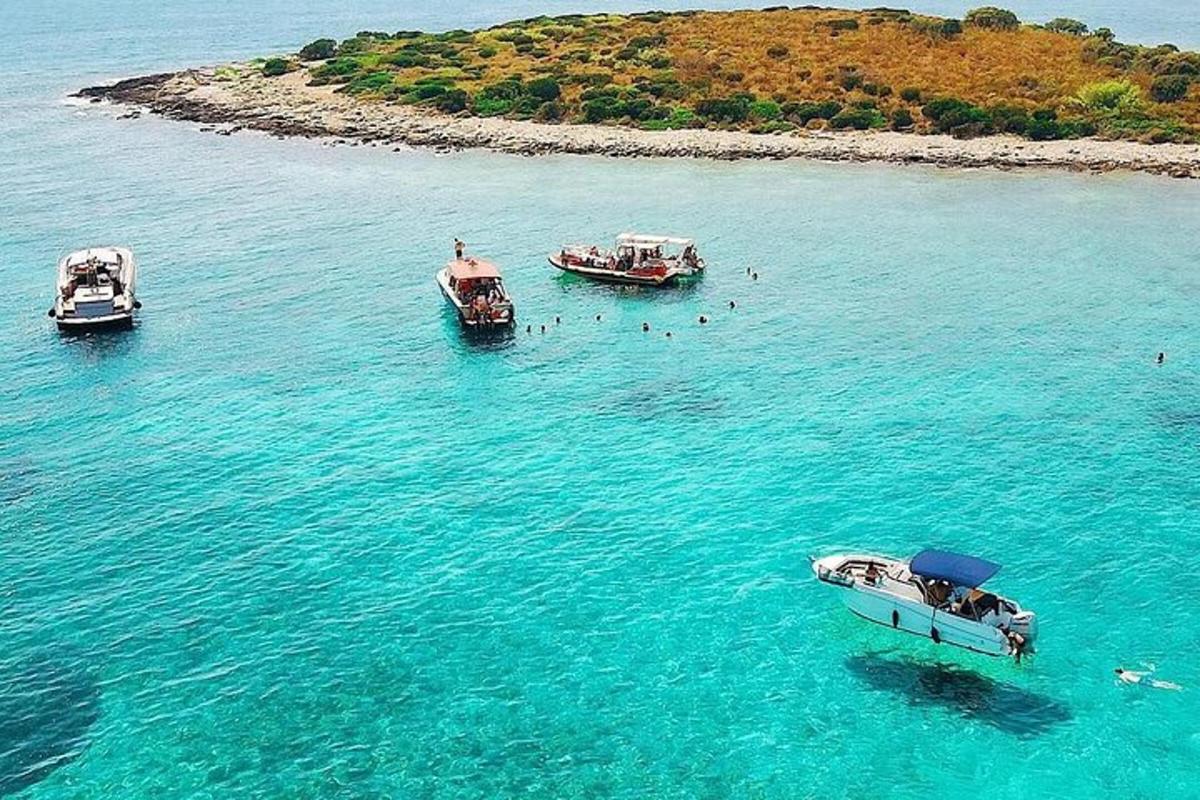 three boats in the water near an island