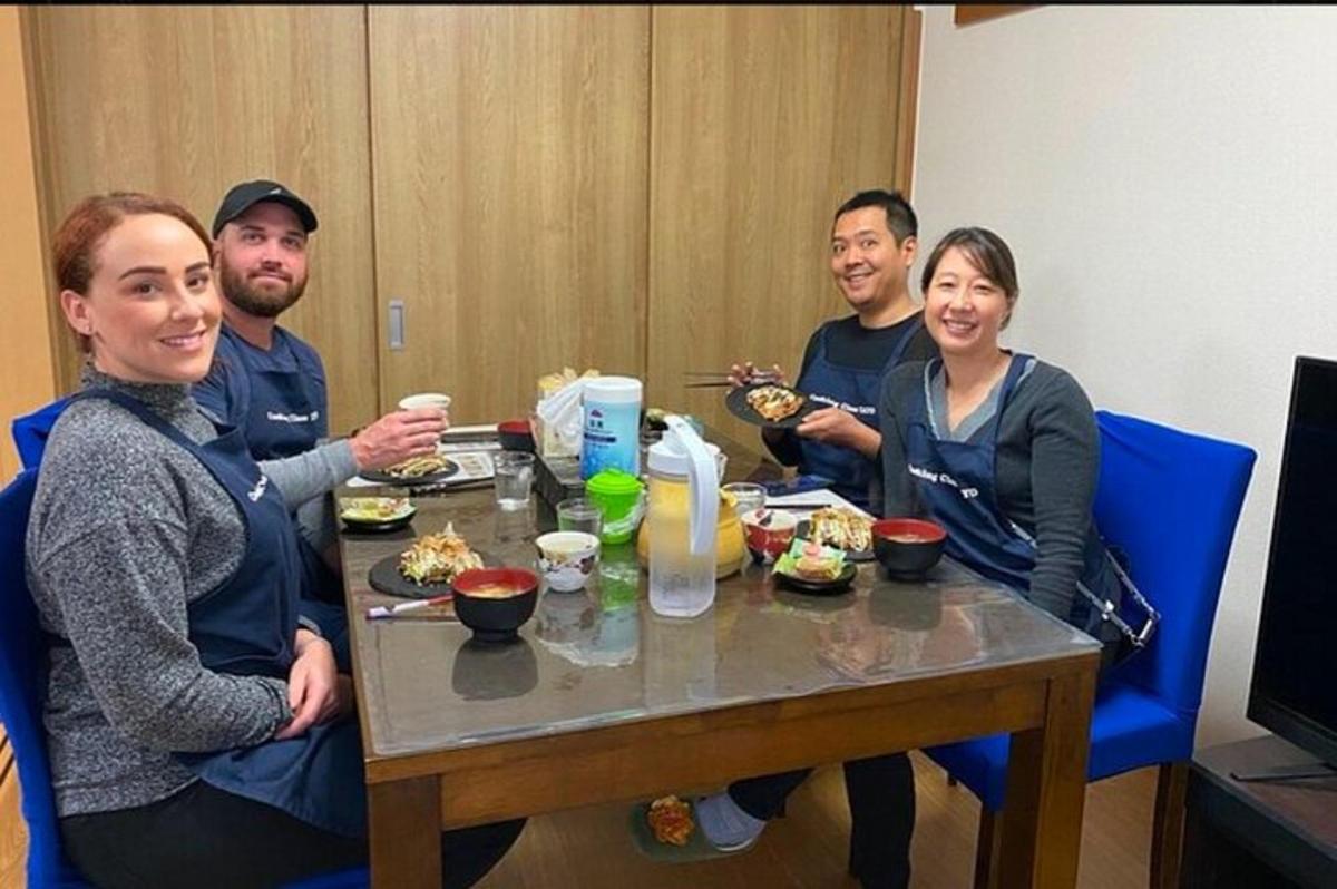 a group of people sitting around a table with food