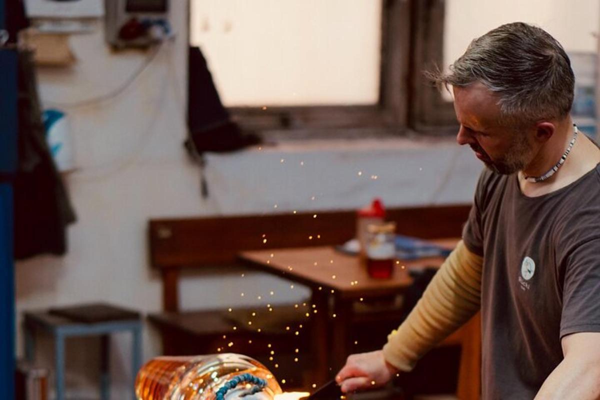 a man is cutting a vase with a knife