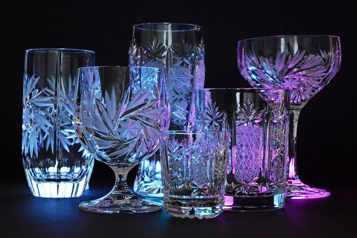 four glass vases sitting on top of a table