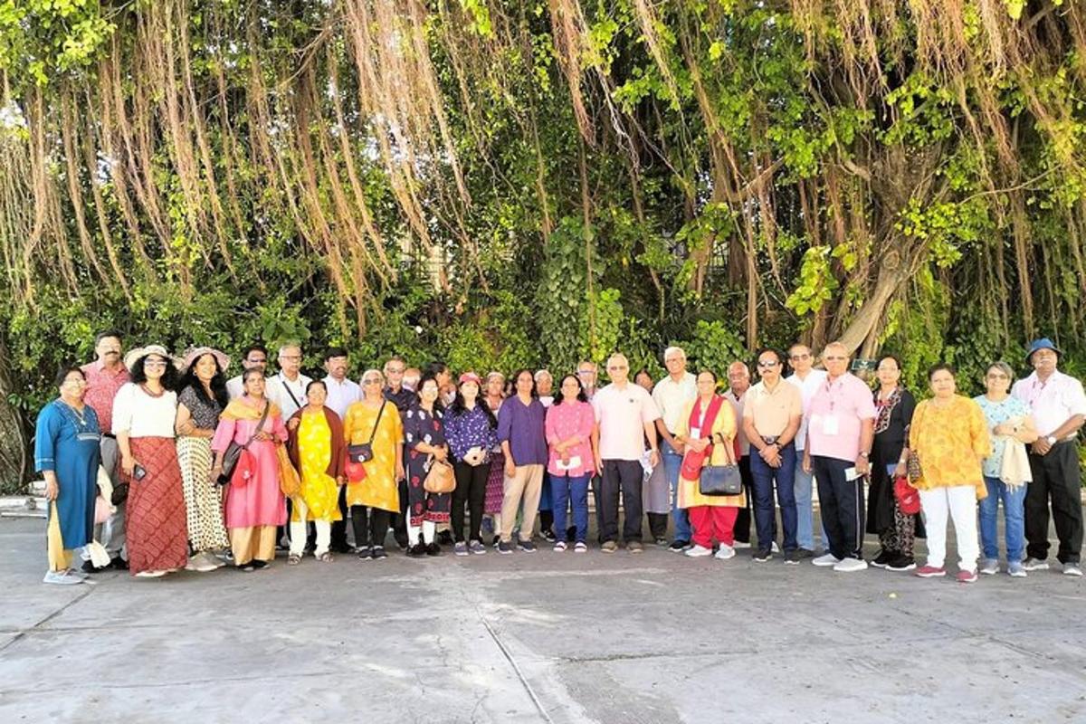 sekelompok orang berpose untuk berfoto di depan pohon