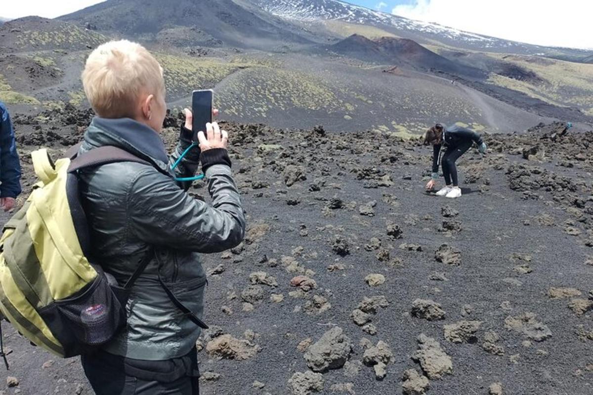um homem tirando uma foto de uma pessoa em uma montanha