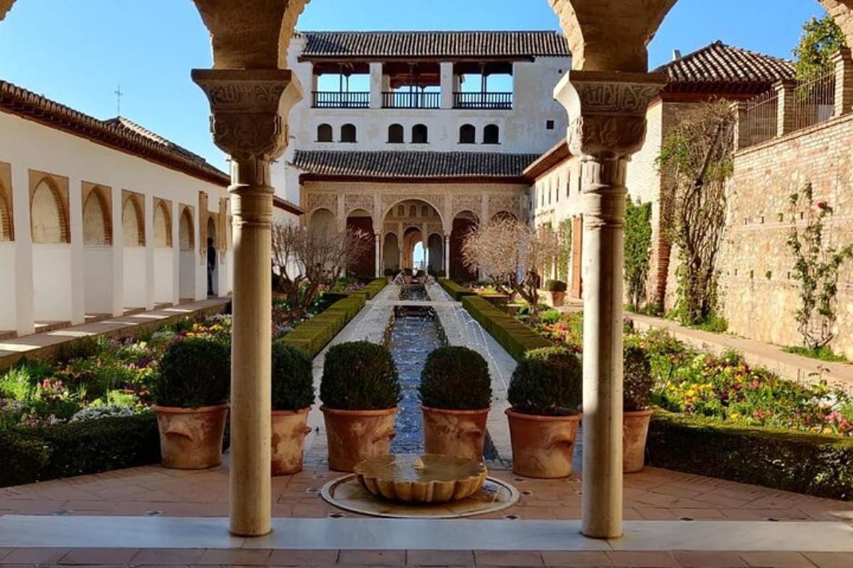 a courtyard of a building with a fountain and plants
