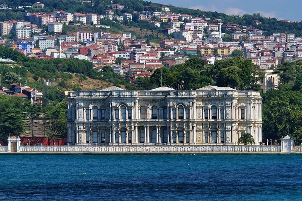 a large building on the water in front of a city