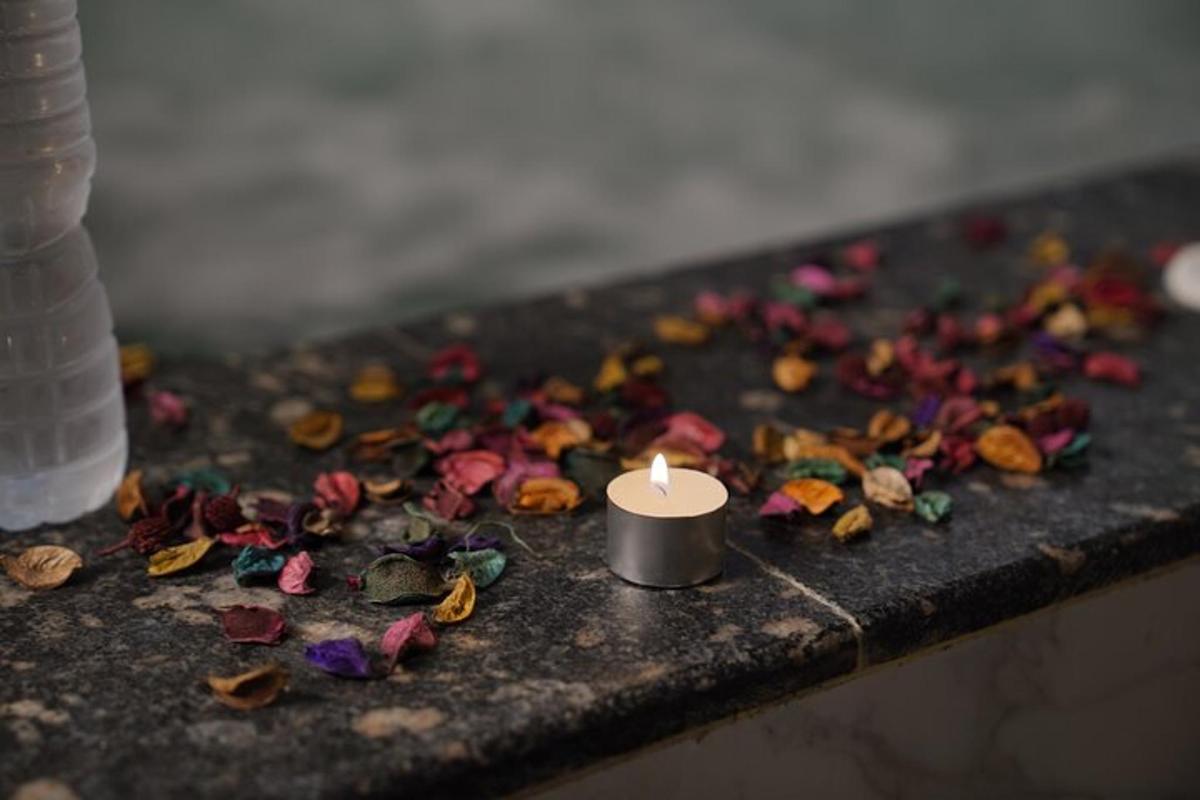 una espelma sobre una taula amb flors
