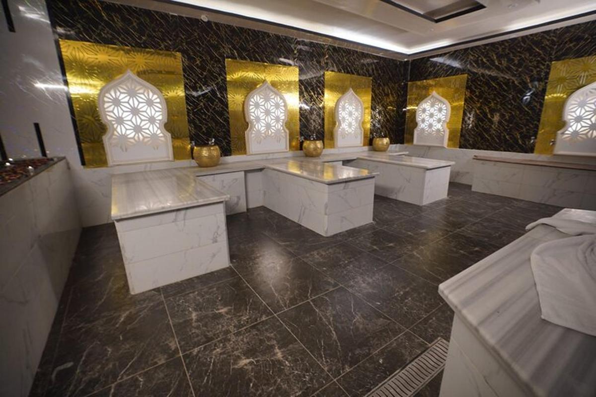 a bathroom with white counters and yellow and black tiles