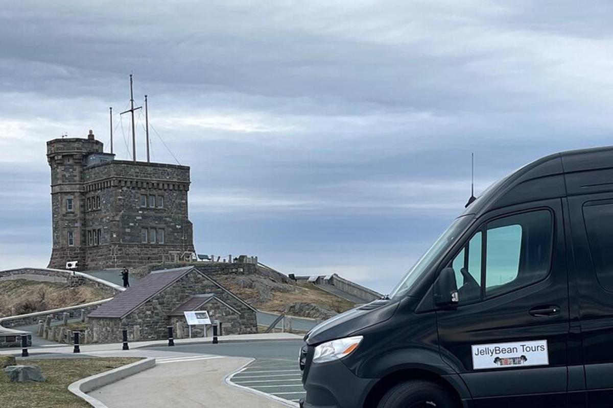 a black van parked in front of a castle