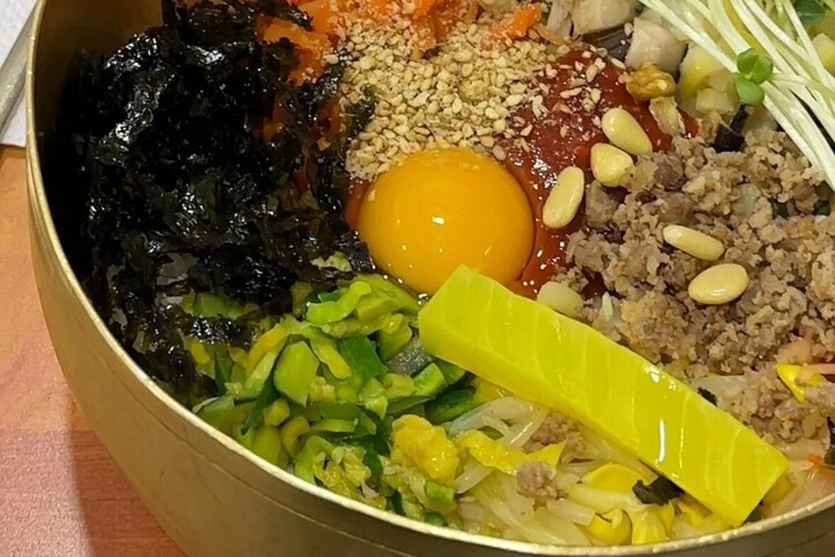 a bowl of food with an egg and other ingredients