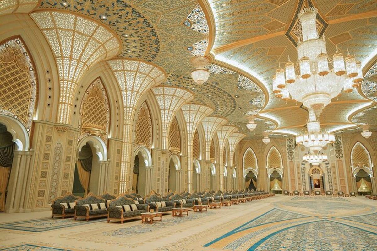 a large lobby with chairs and chandeliers in a building