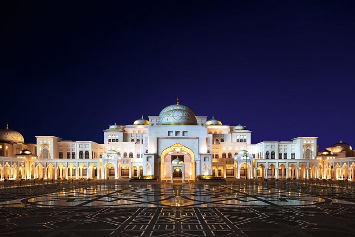 a large white building with a dome on top at night