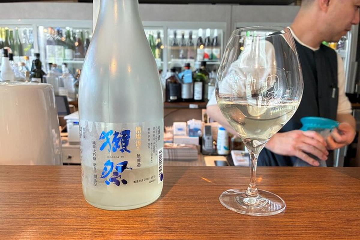 en flaske hvitvin som står ved siden av et glass