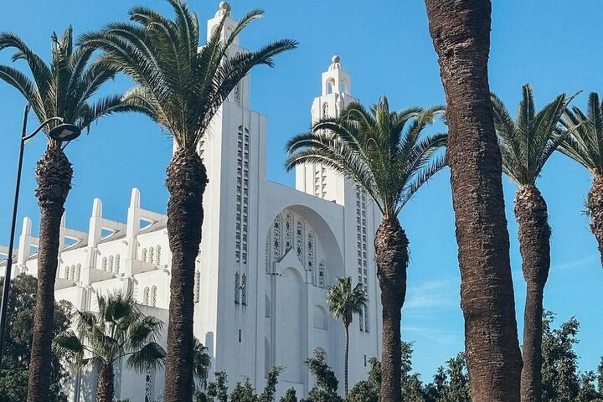 a large white building with palm trees in front of it