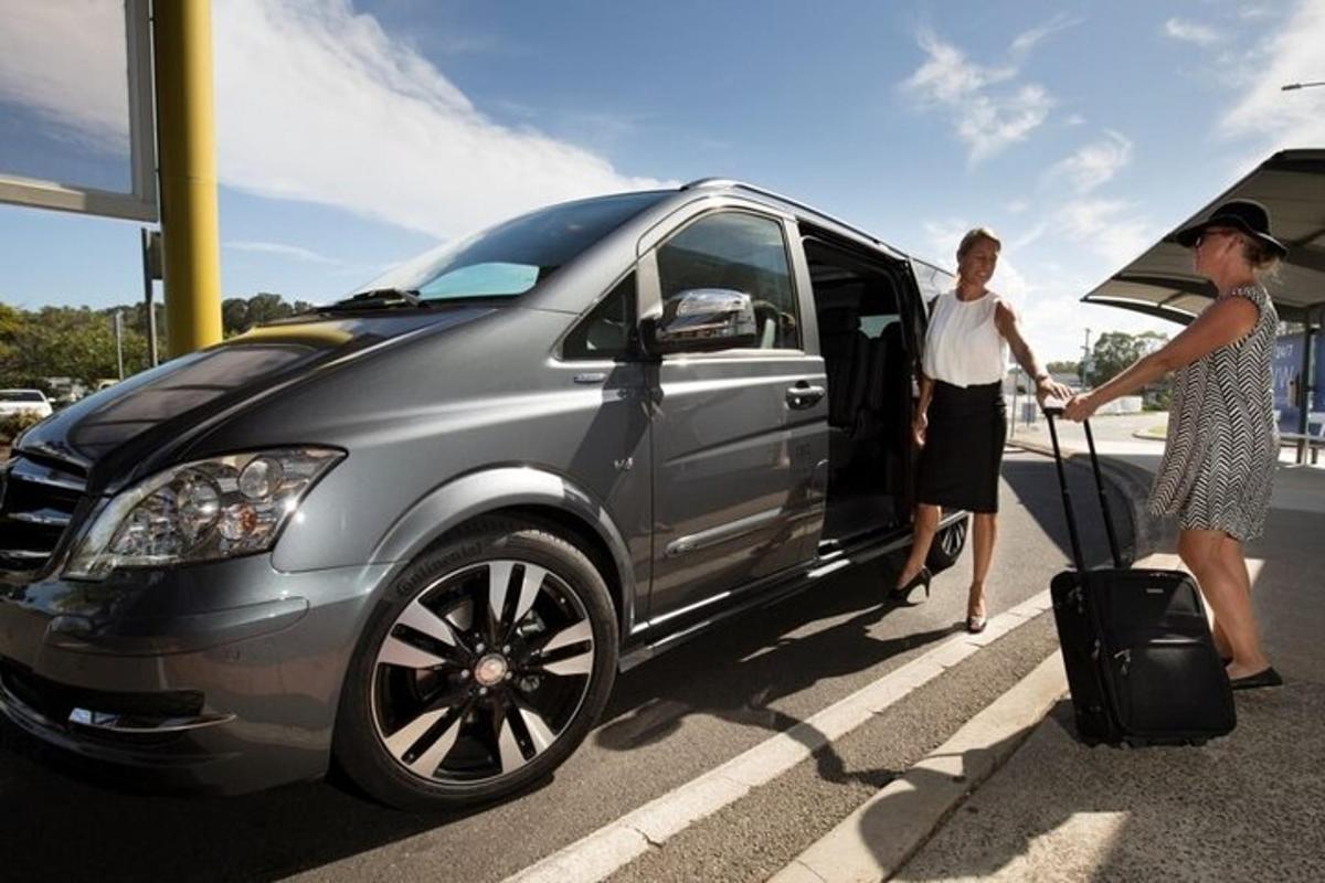 a man and a woman getting into a car